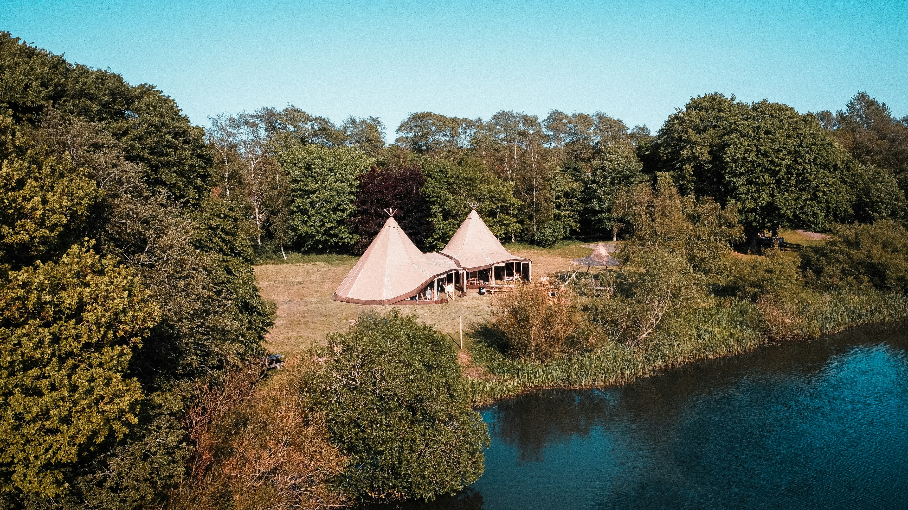a large tent is set up next to a river
