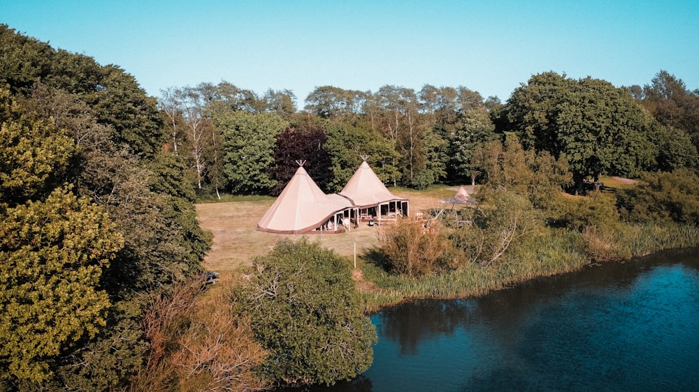 a large tent is set up next to a river