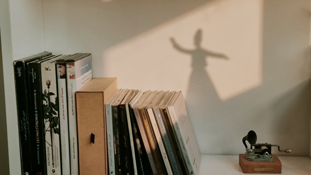 a shadow of a person on a wall next to a book shelf