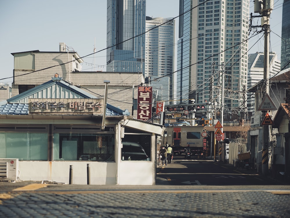 a city street lined with tall buildings in the background