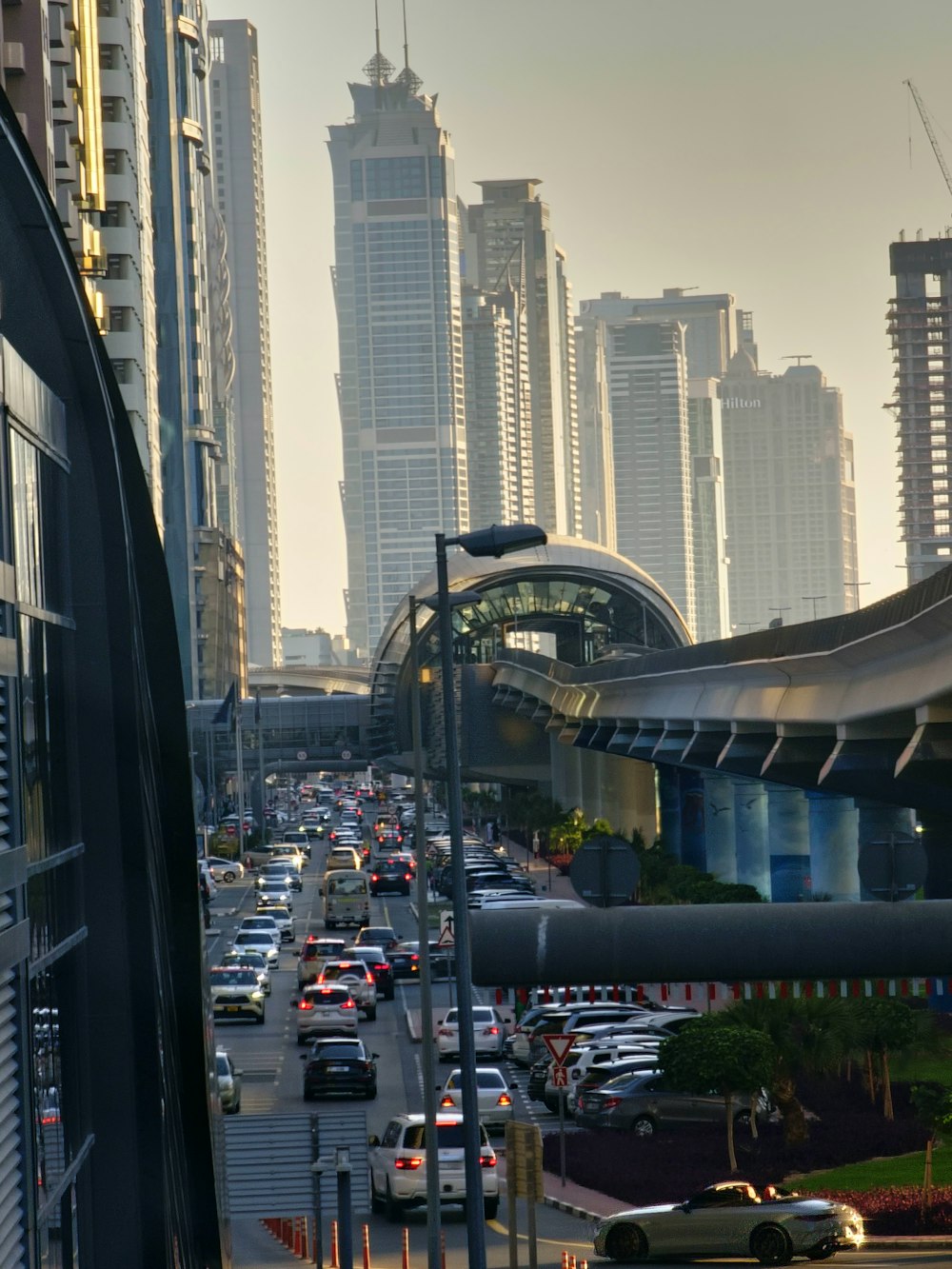 a city street filled with lots of traffic next to tall buildings