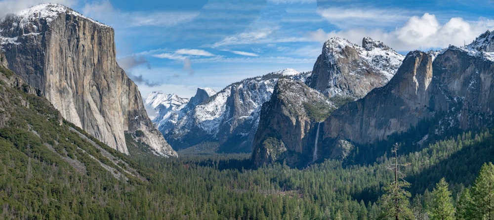 a mountain range with snow capped mountains in the background