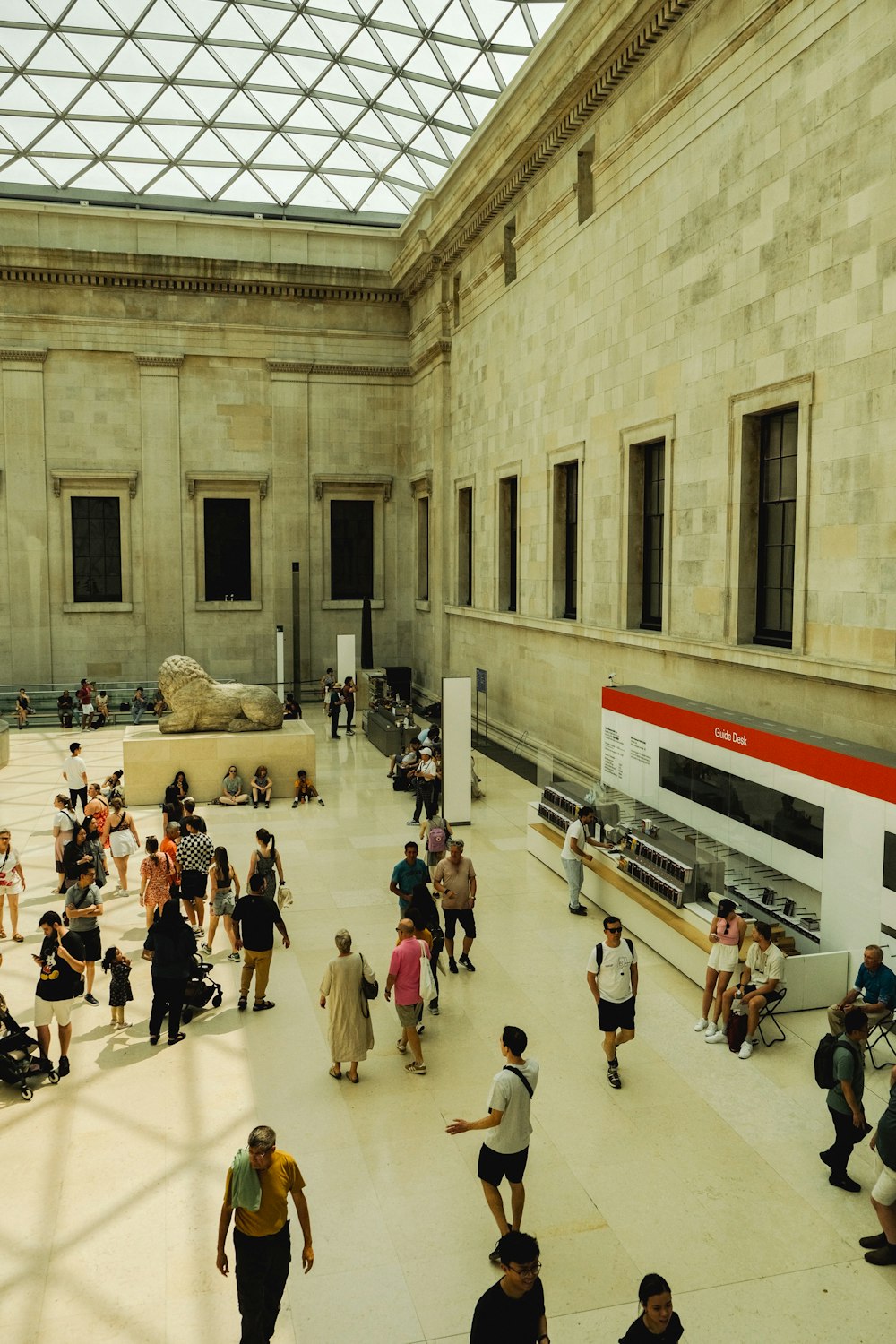 a group of people walking around a museum