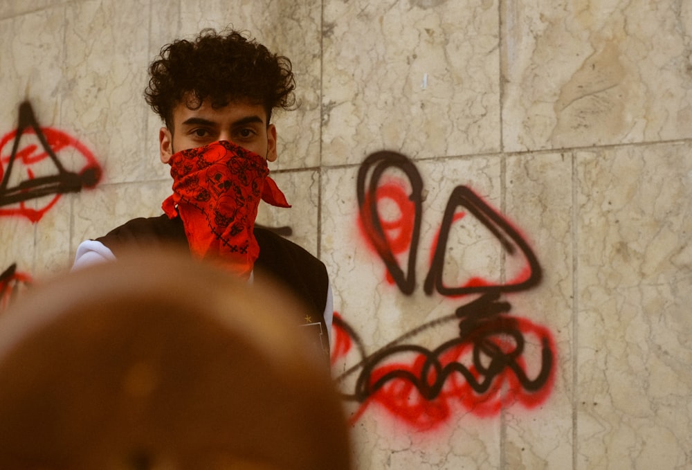 a man with a red scarf covering his face