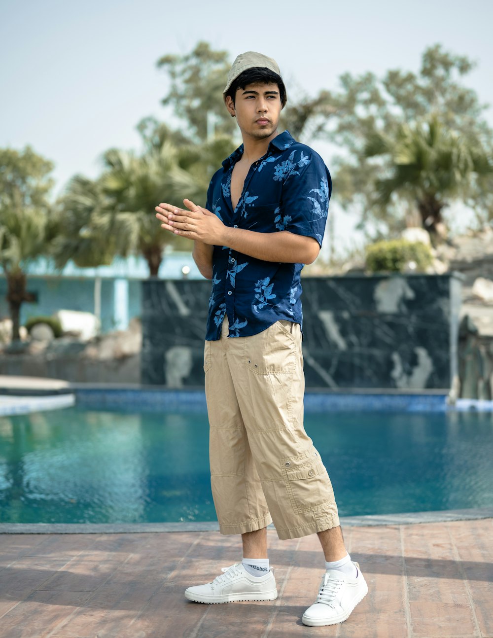 a man standing in front of a swimming pool