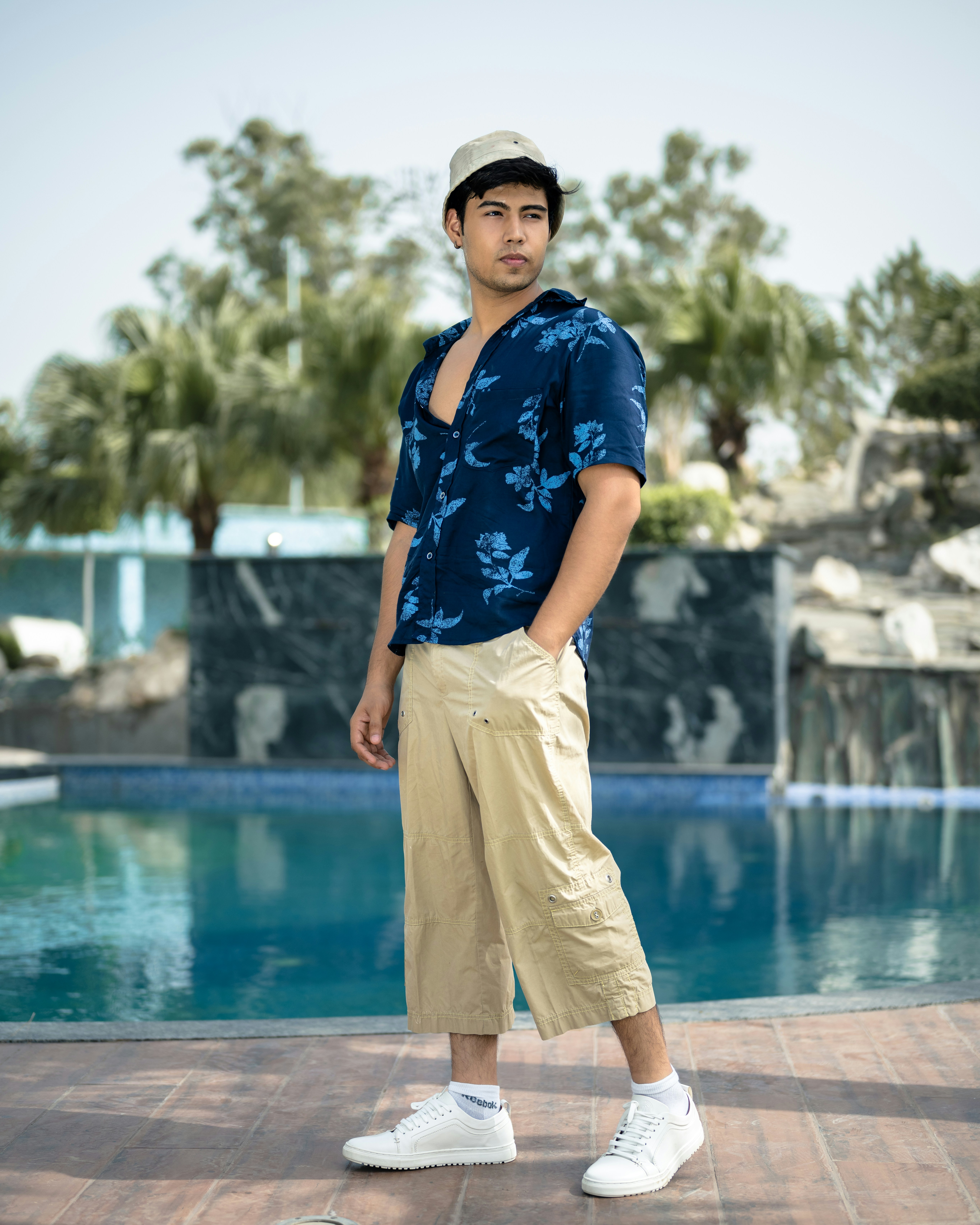 a man standing in front of a swimming pool