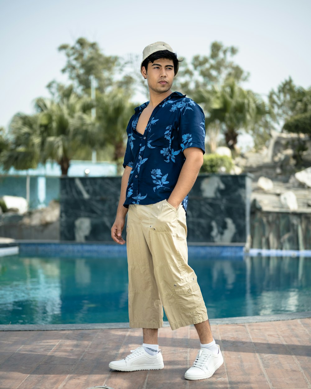 a man standing in front of a swimming pool