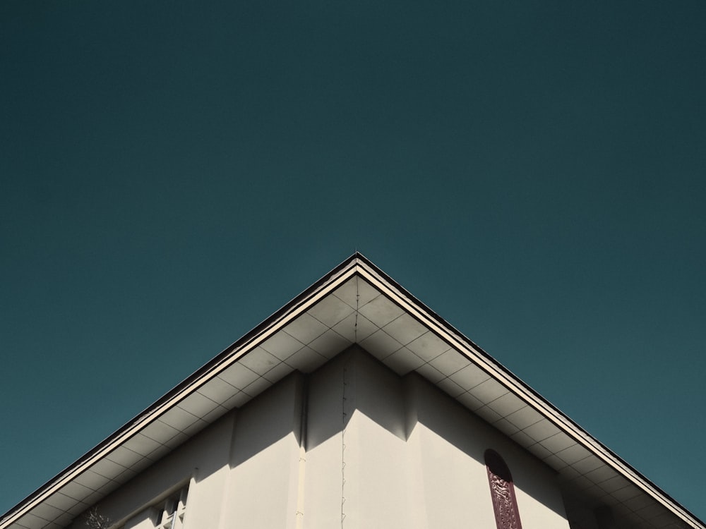 the top of a white building against a blue sky