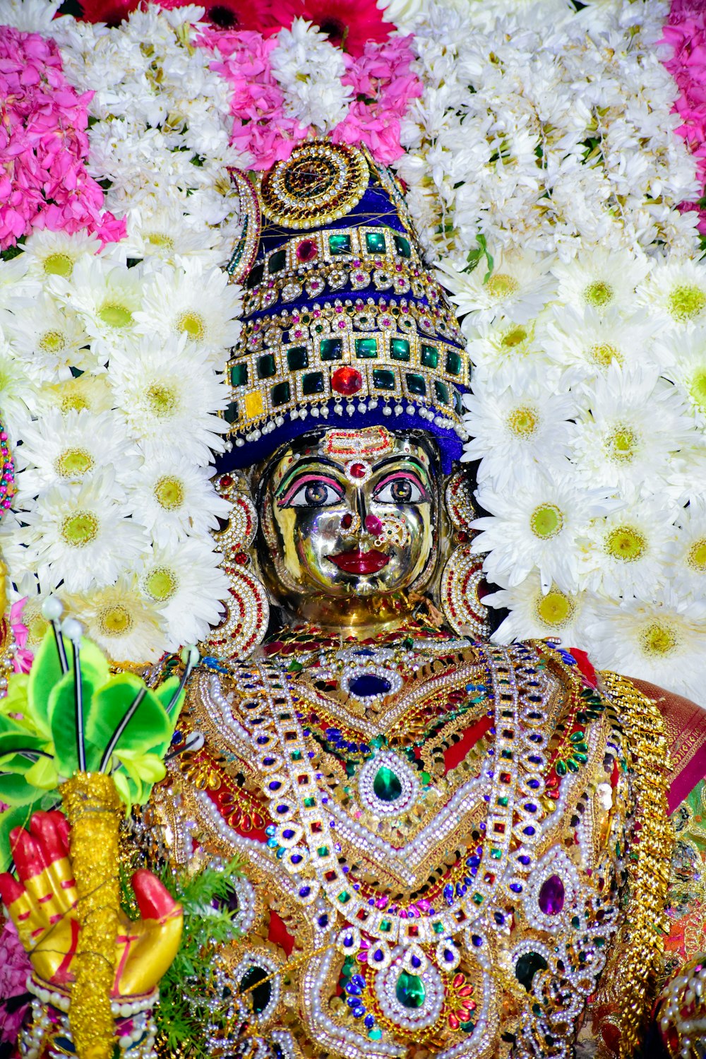 a close up of a statue of a person surrounded by flowers