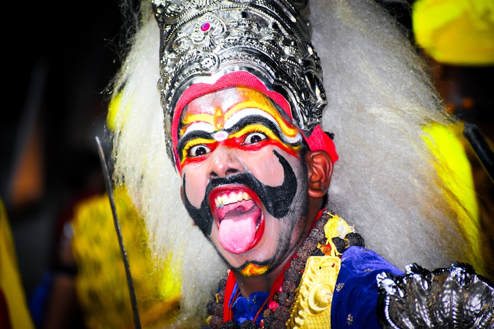 a man with a face painted like a clown