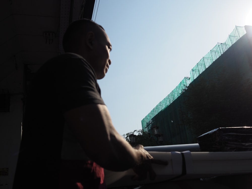 a man standing next to a white truck under a blue sky