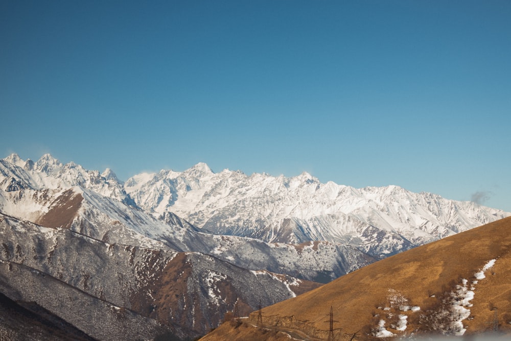 a view of a mountain range with snow on it