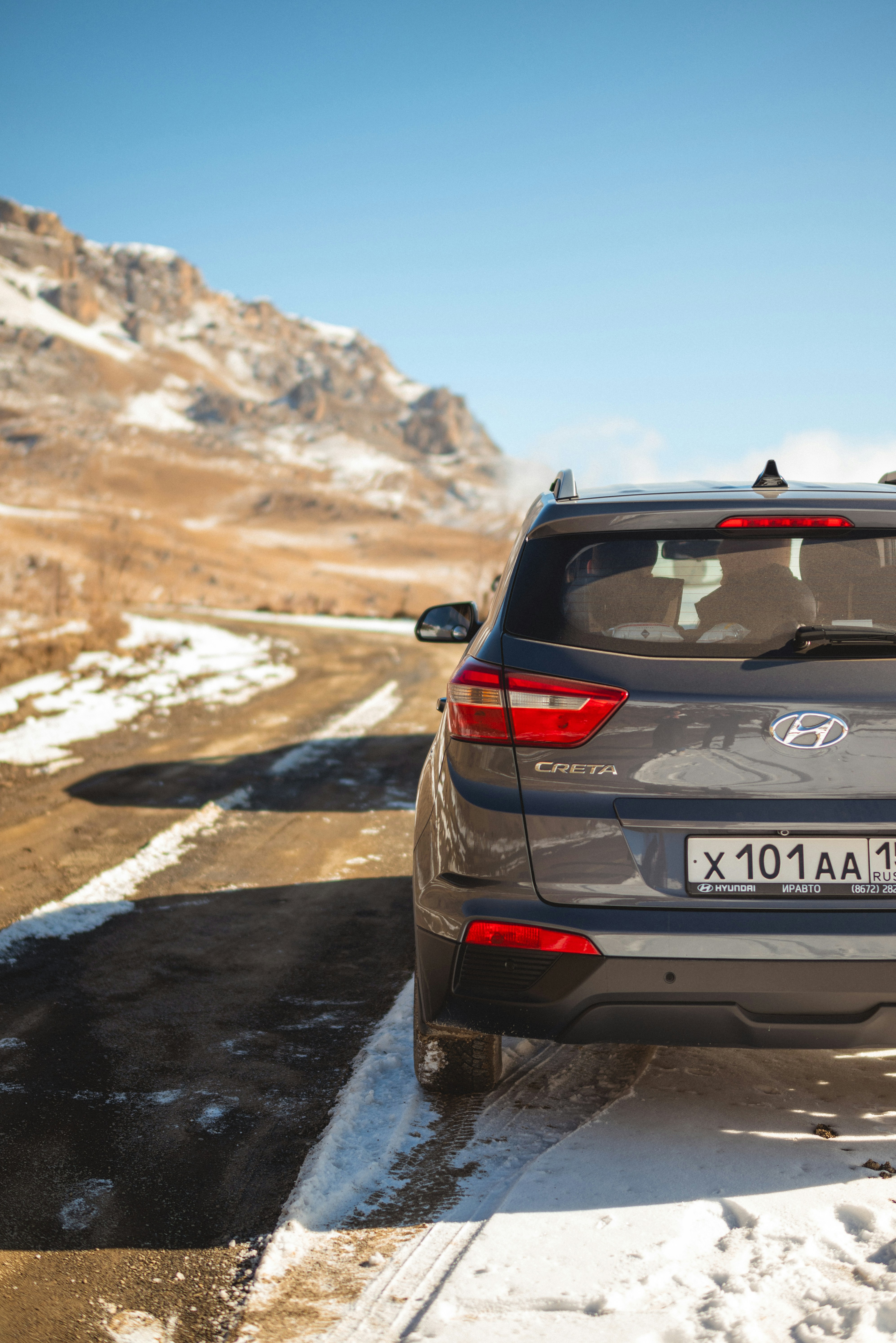 White Hyundai Creta SUV on a highway with clear blue sky