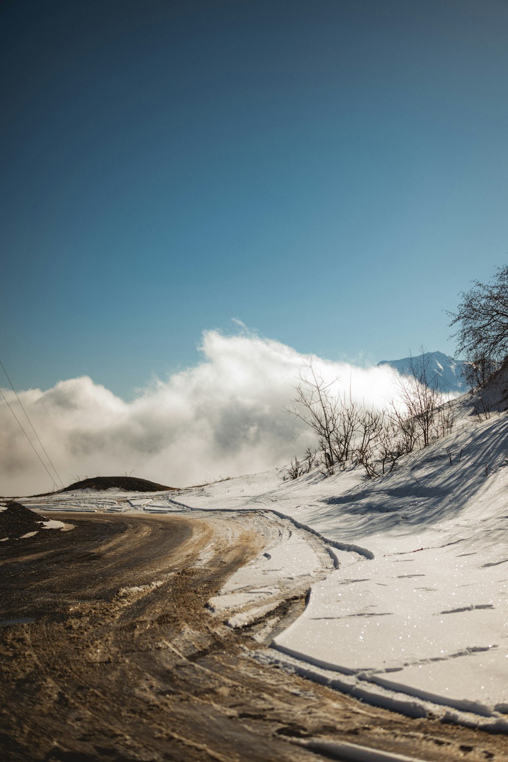 a person riding a snowboard down a snow covered slope