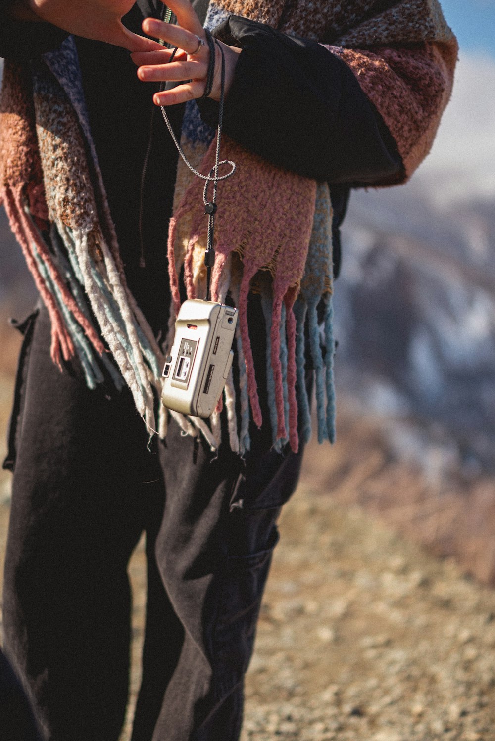 a person standing on a hill with a cell phone