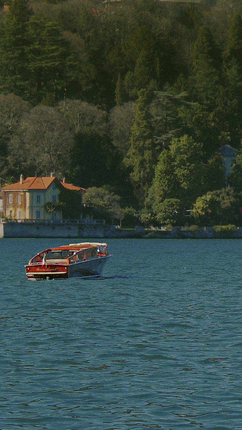 a red boat traveling across a large body of water