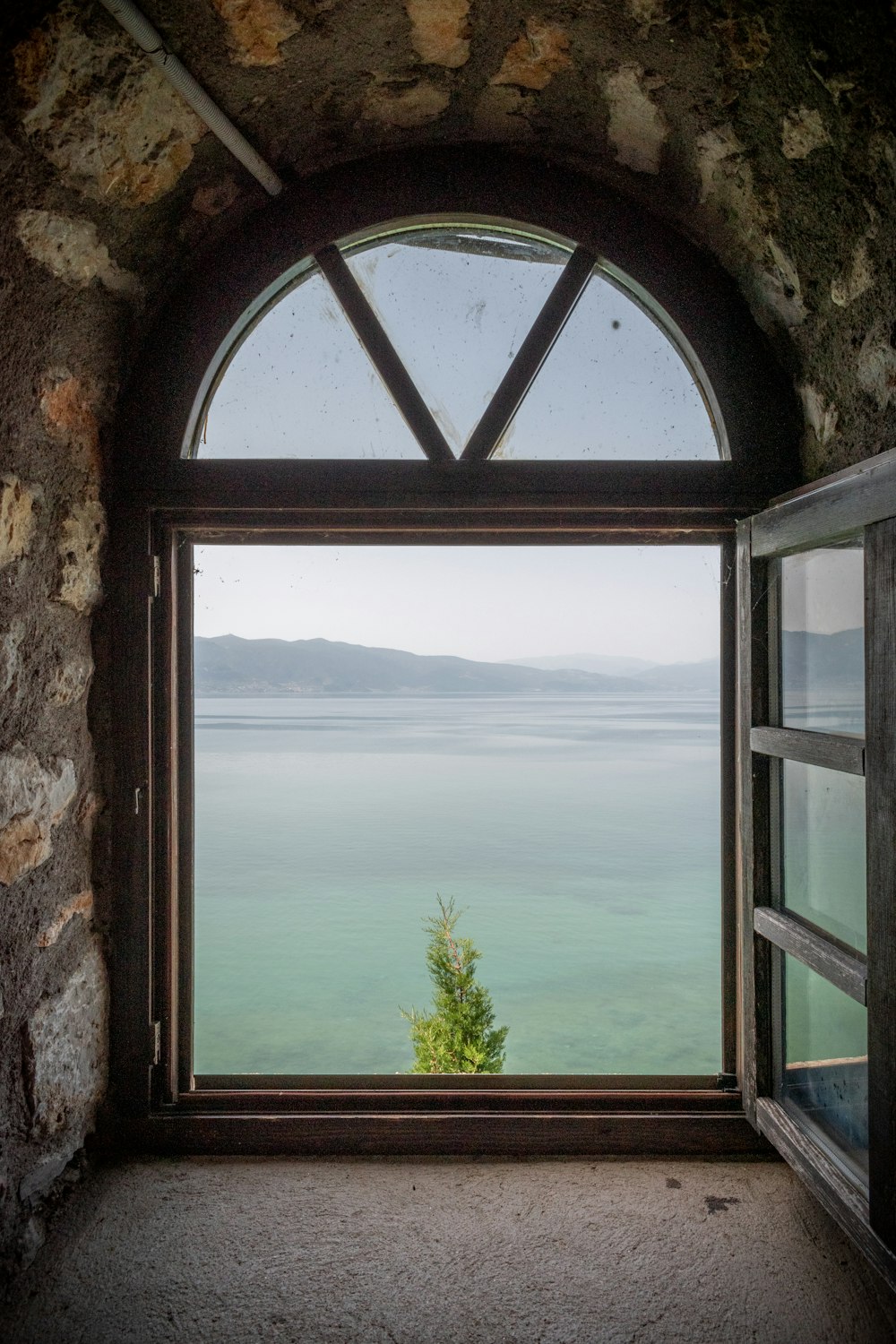 a window with a view of the ocean