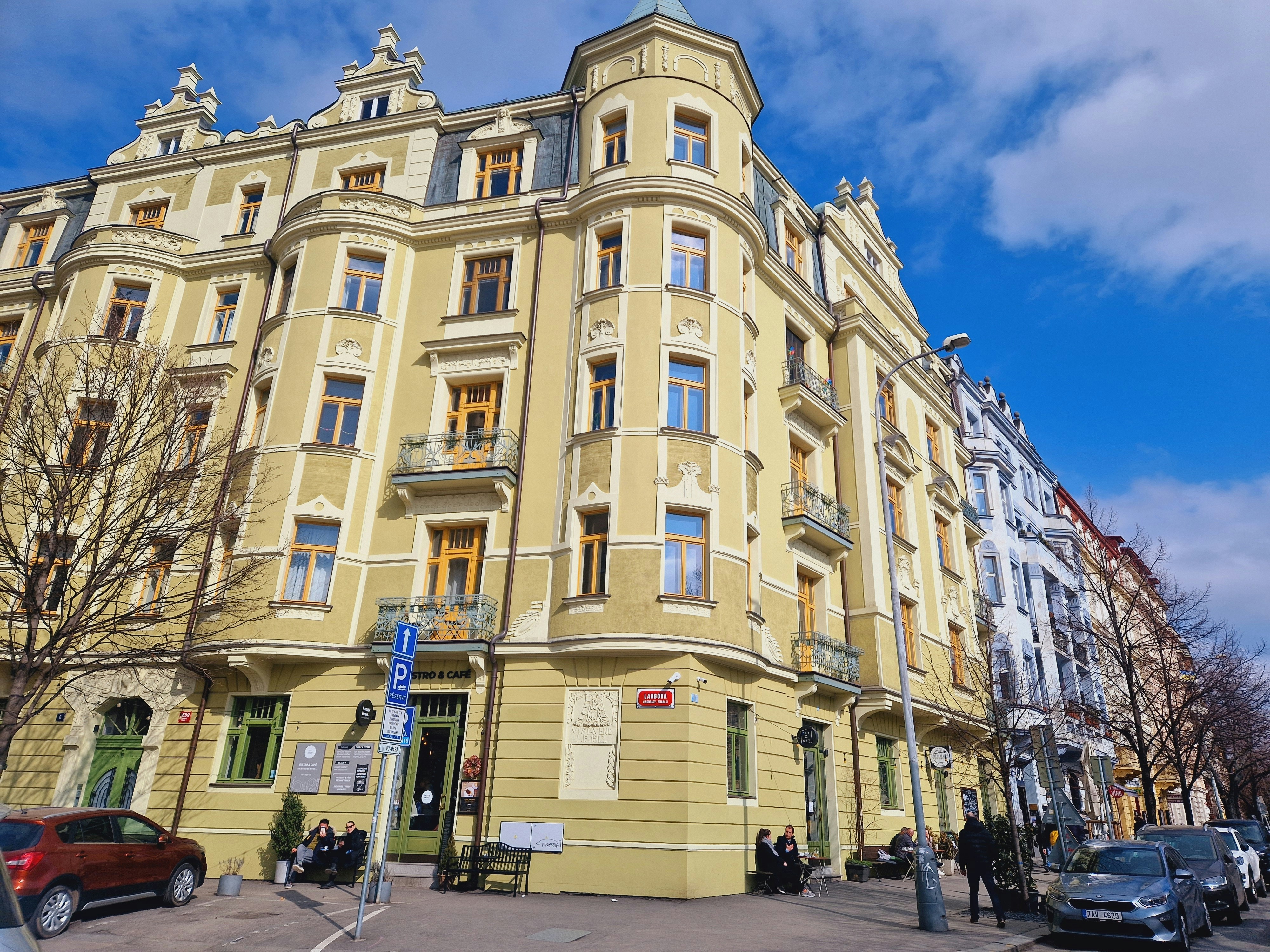 a large yellow building on a city street, 