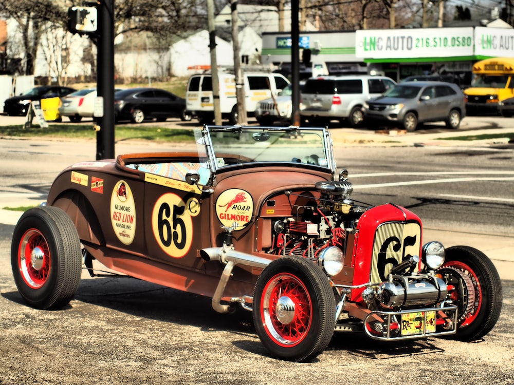 an old model car is parked on the side of the road