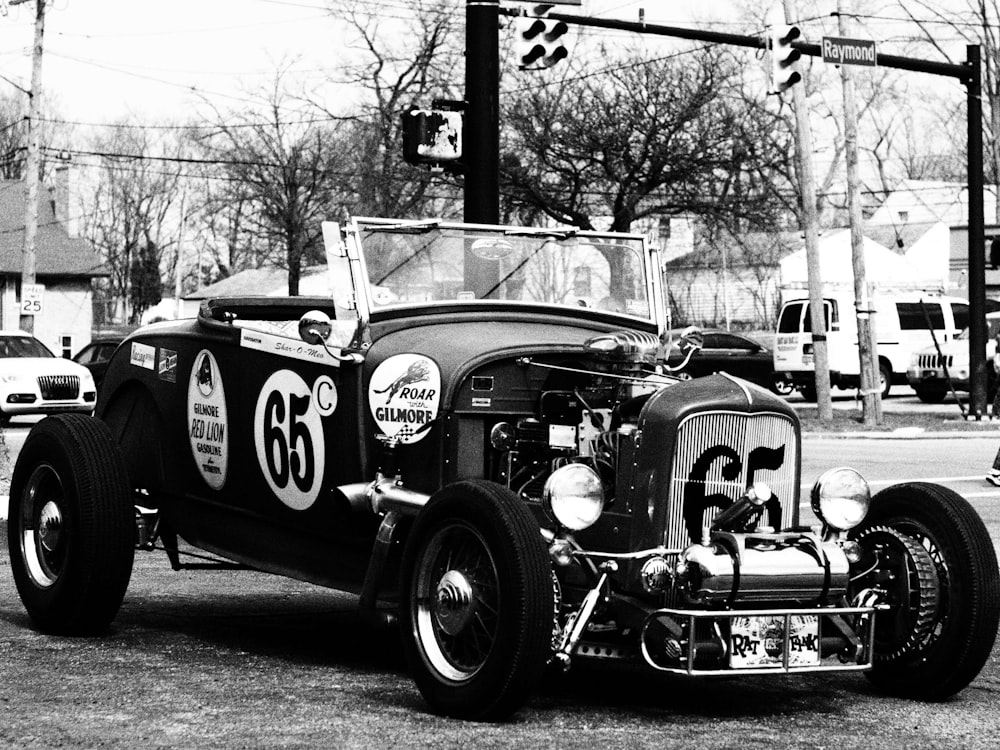 a black and white photo of an old race car