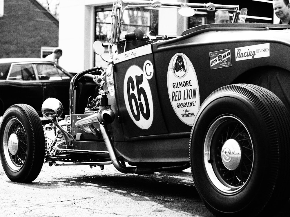 a black and white photo of an old car