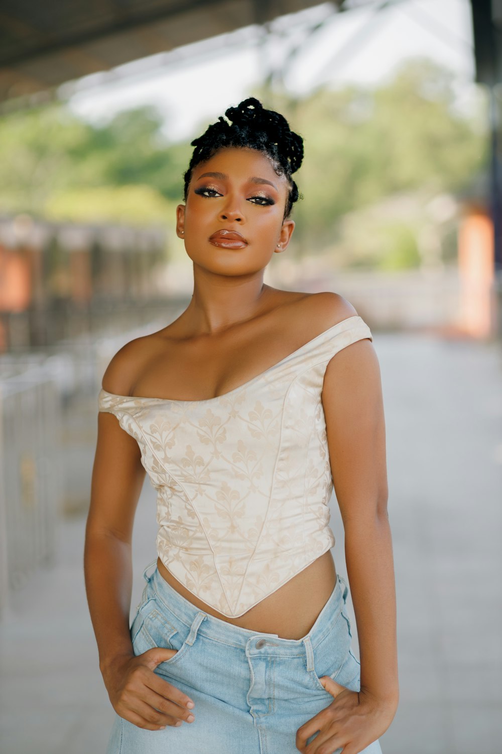 a woman wearing a white top and jeans