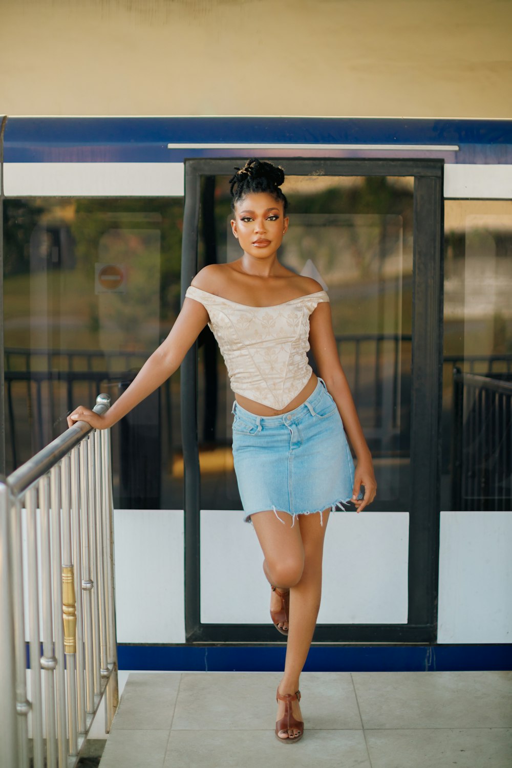 a woman in a white top and a blue skirt