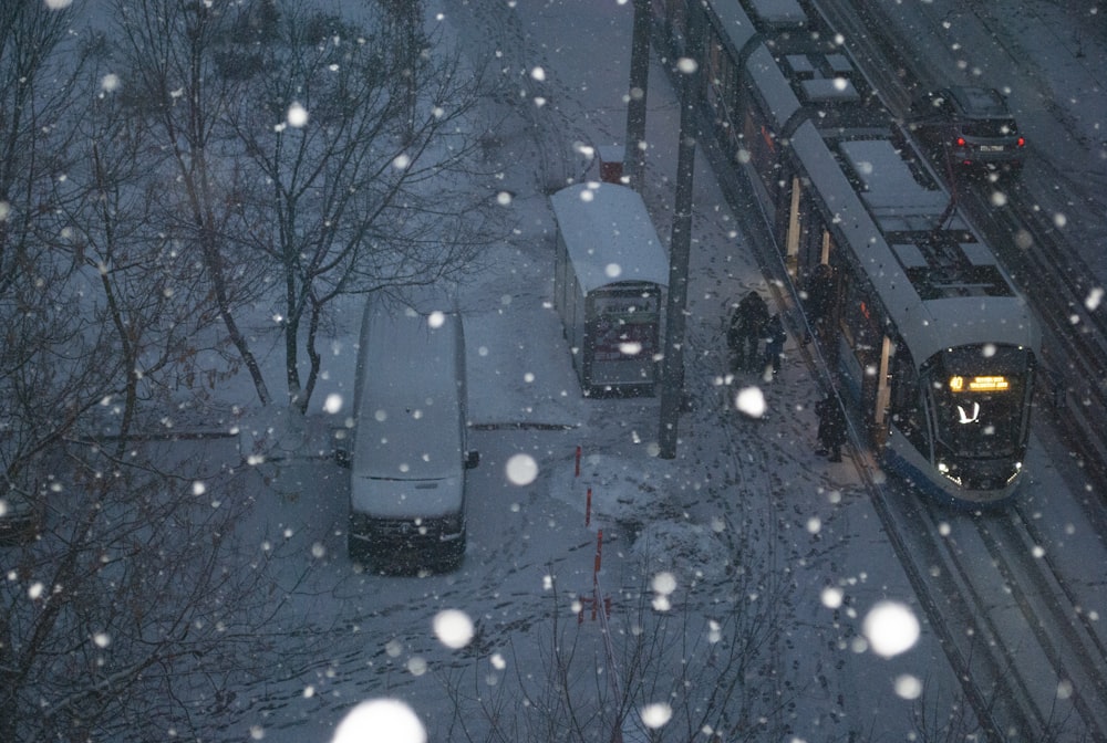 a train traveling through a snow covered forest