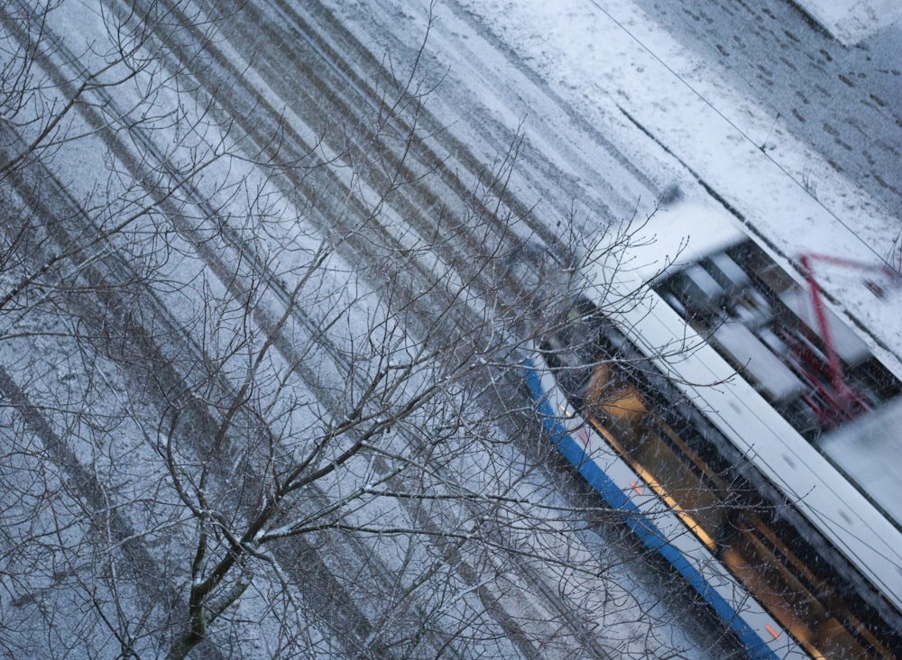 a bus driving down a snow covered road
