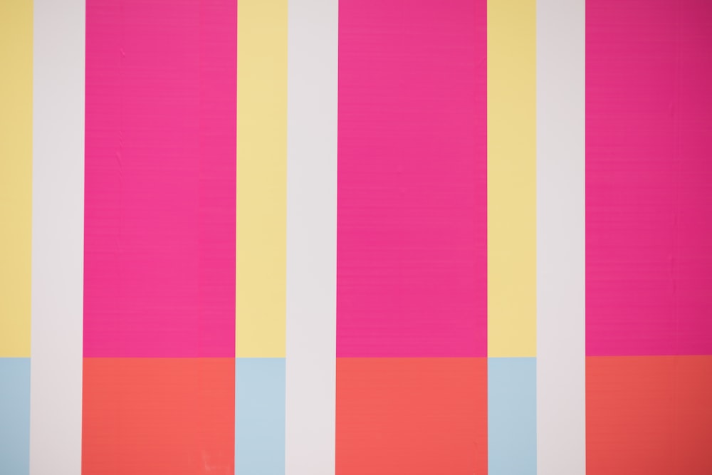 a pink, yellow, and blue striped wallpaper