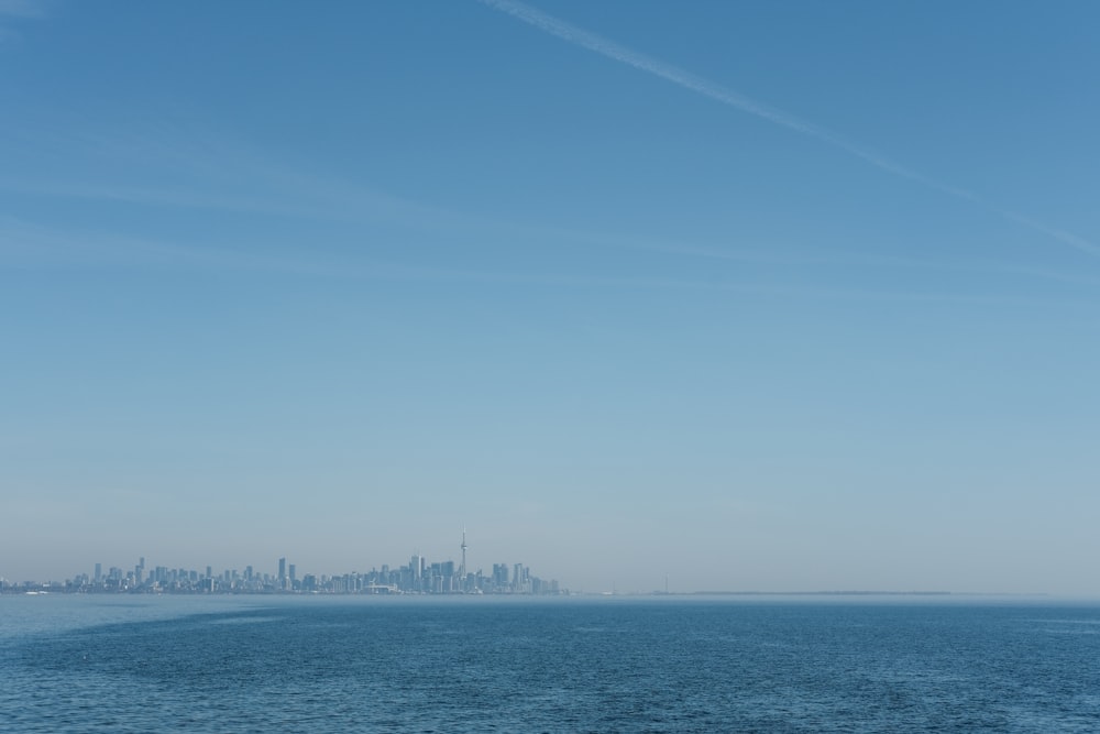 a large body of water with a city in the background