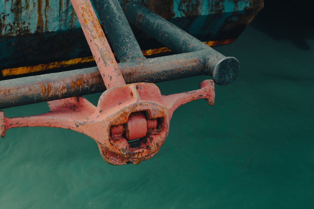a close up of a rusted metal object in the water,