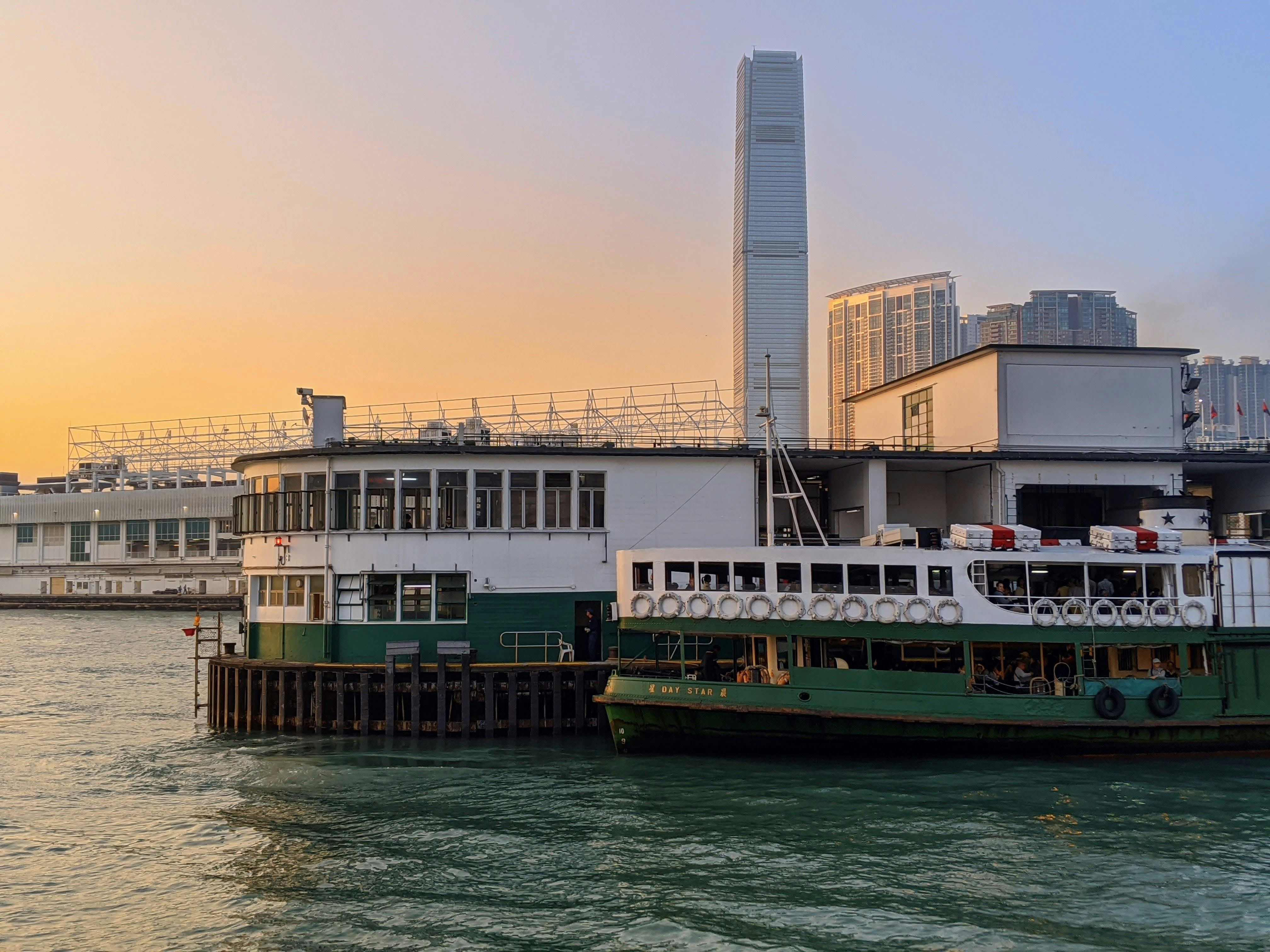 a ferry is docked in front of a large building