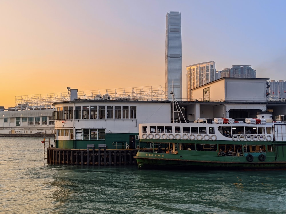 a ferry is docked in front of a large building