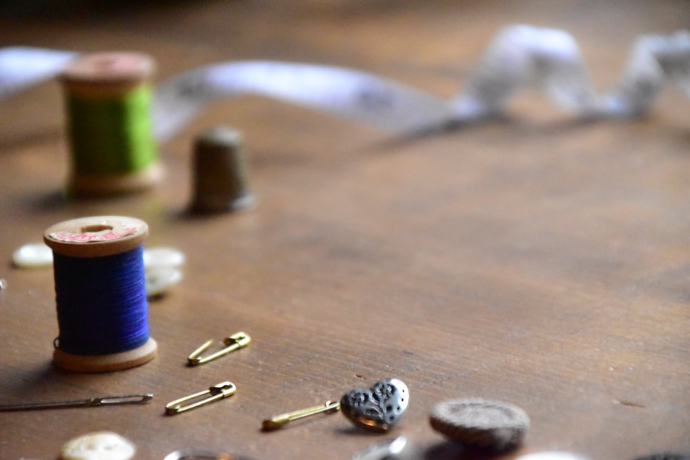 a wooden table topped with lots of sewing supplies