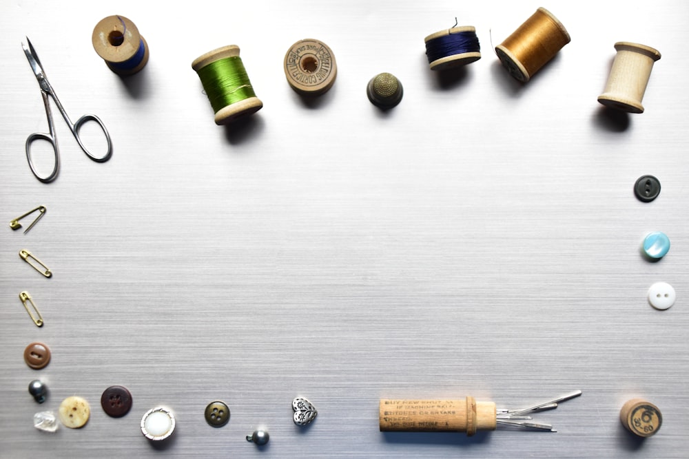 a table topped with lots of different types of sewing supplies