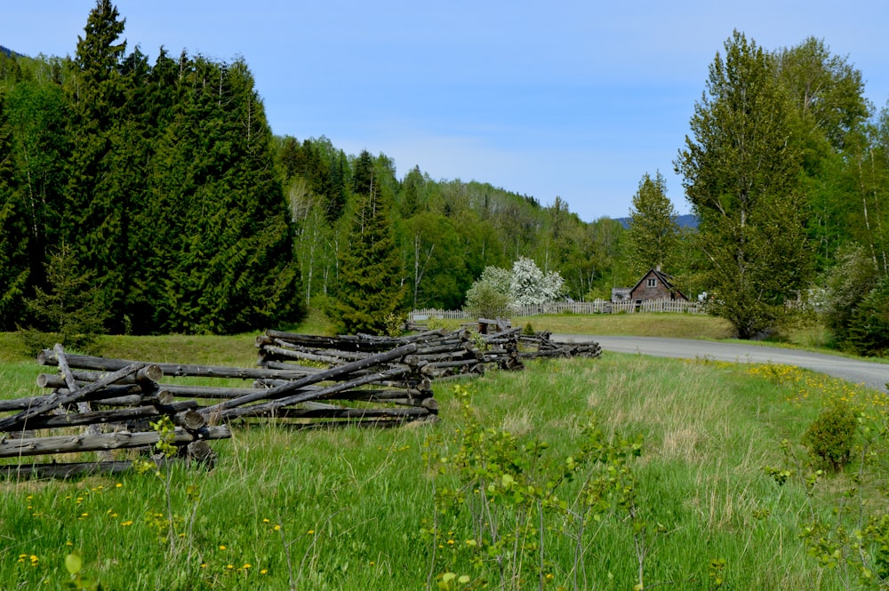 a wooden fence sitting in the middle of a lush green field