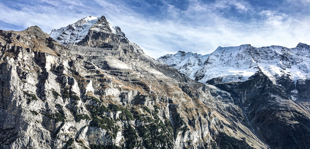 a mountain range with snow covered mountains in the background