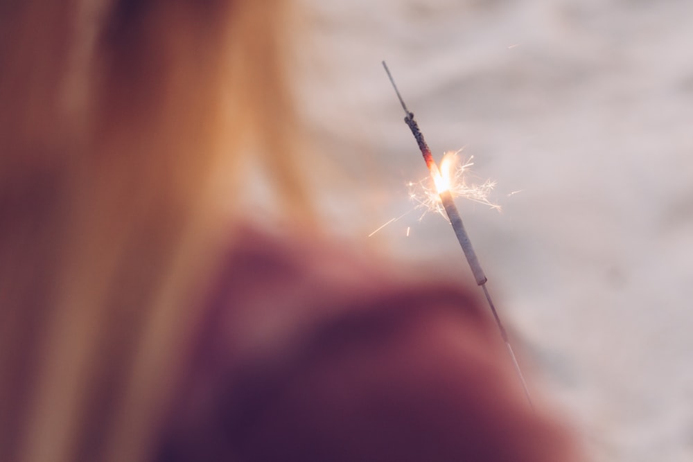 a woman holding a sparkler in her hand