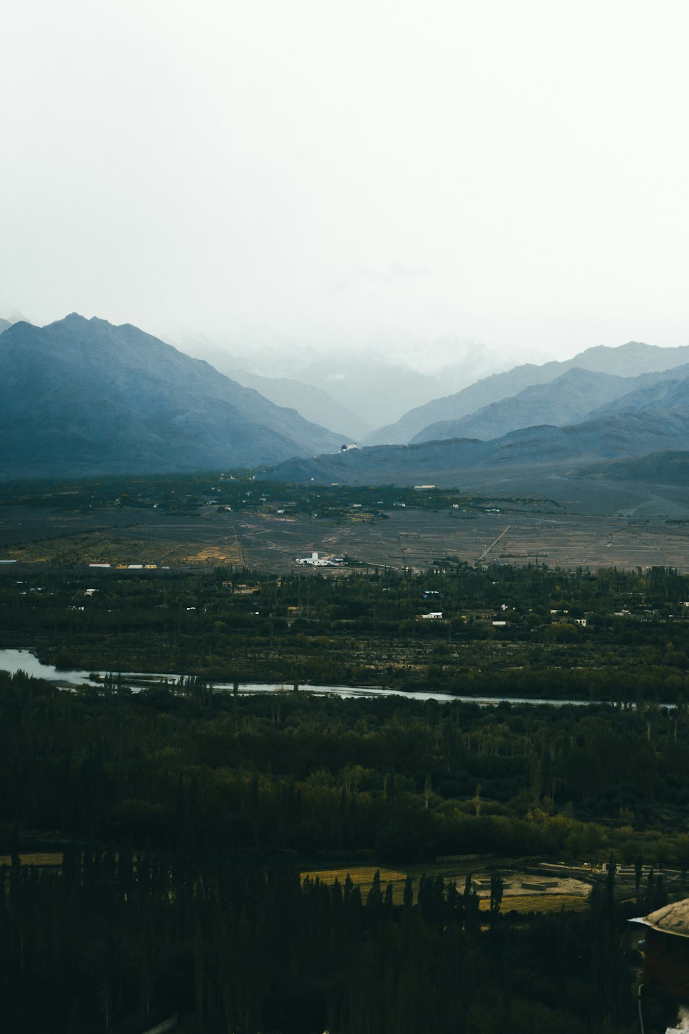 a view of a valley with mountains in the background