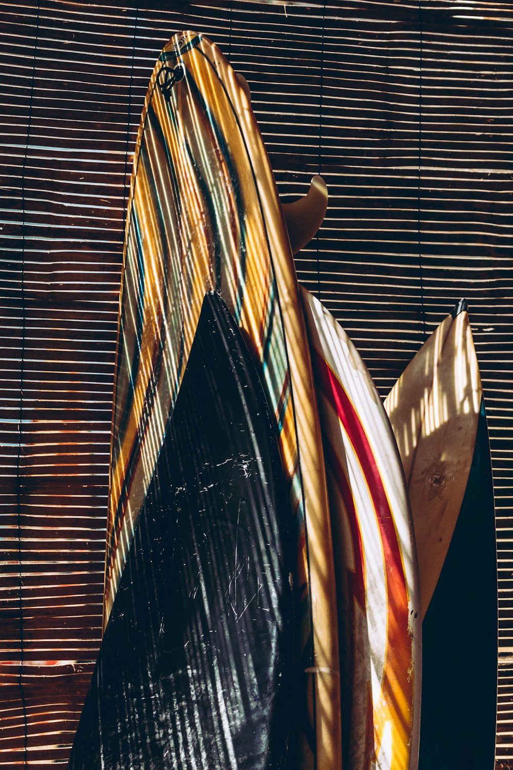 a surfboard leaning up against a wooden wall