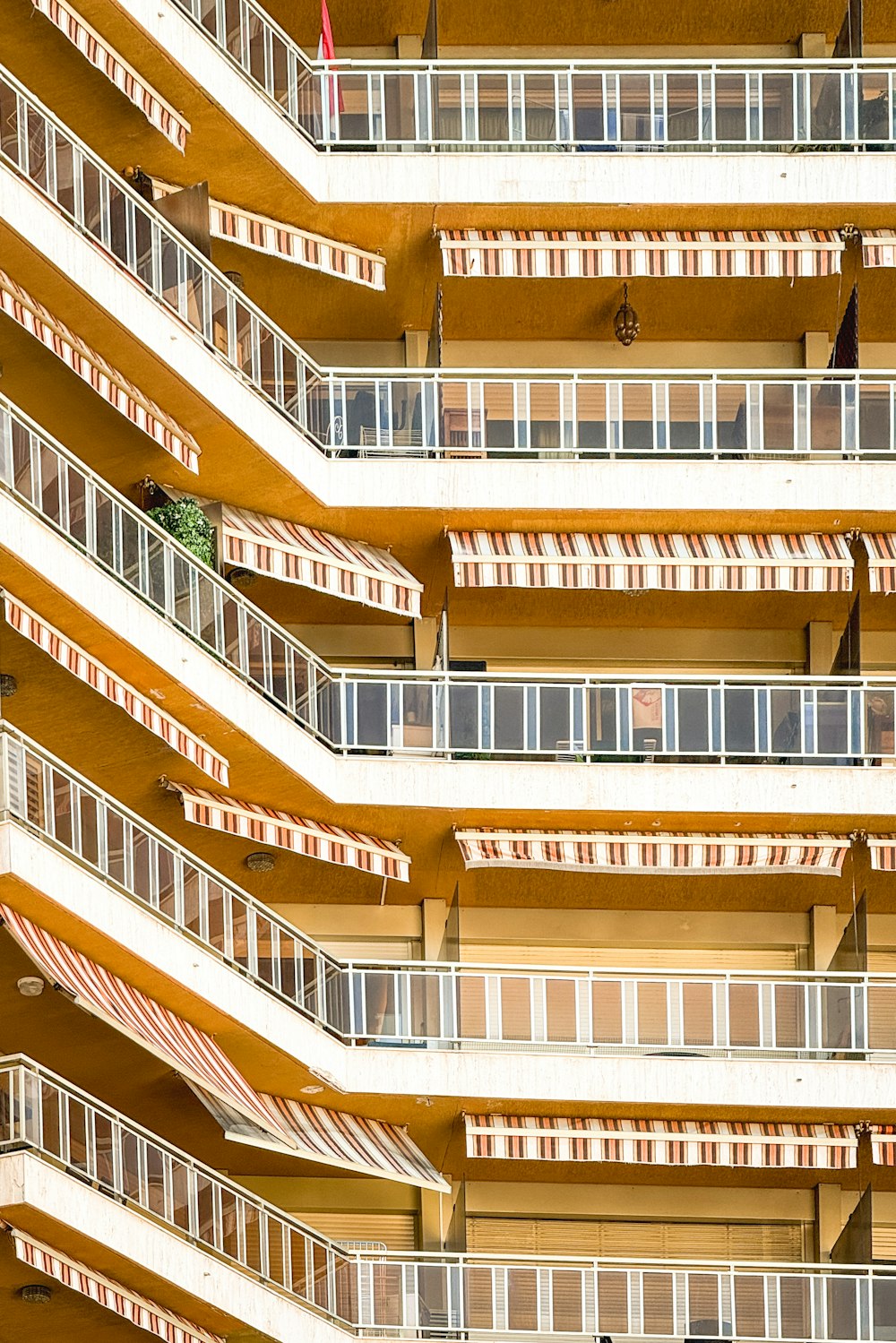 a building with balconies and a clock on the top of it