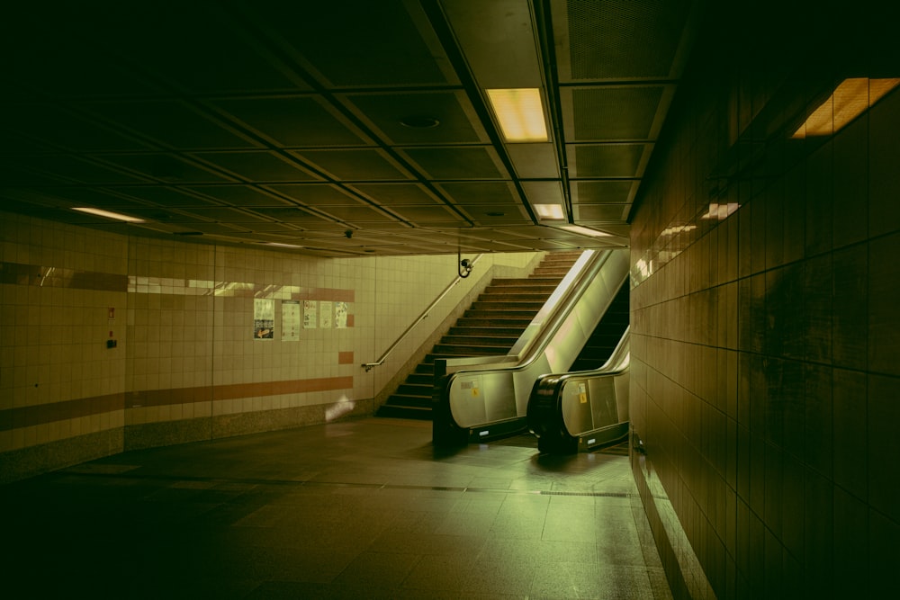 a subway station with stairs and a trash can