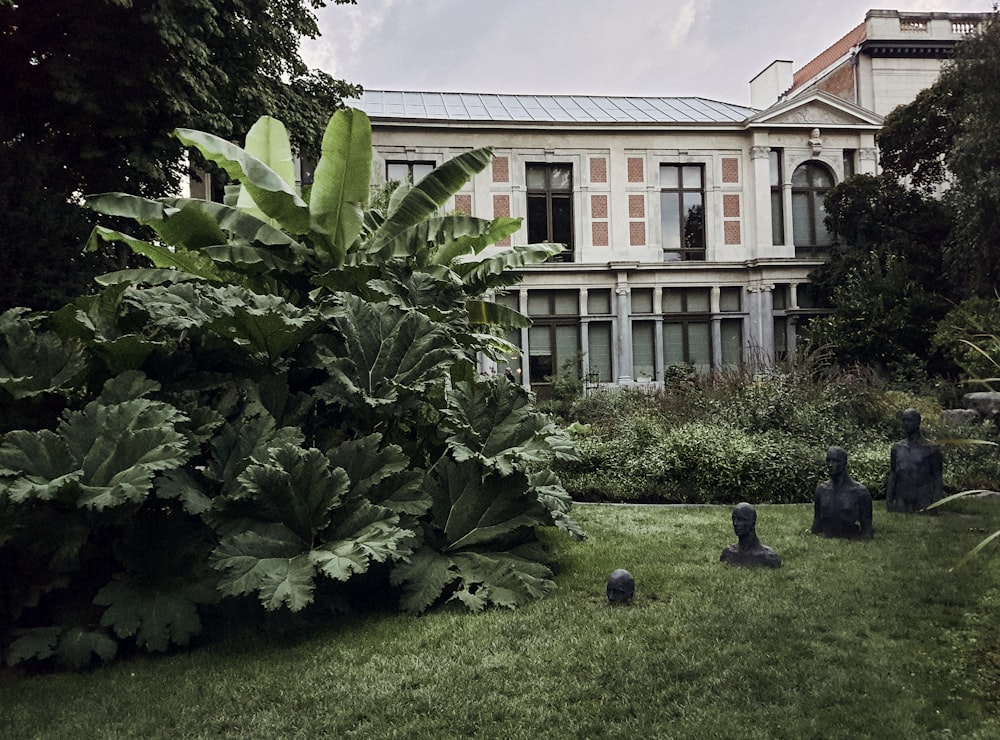 a large building sitting next to a lush green park