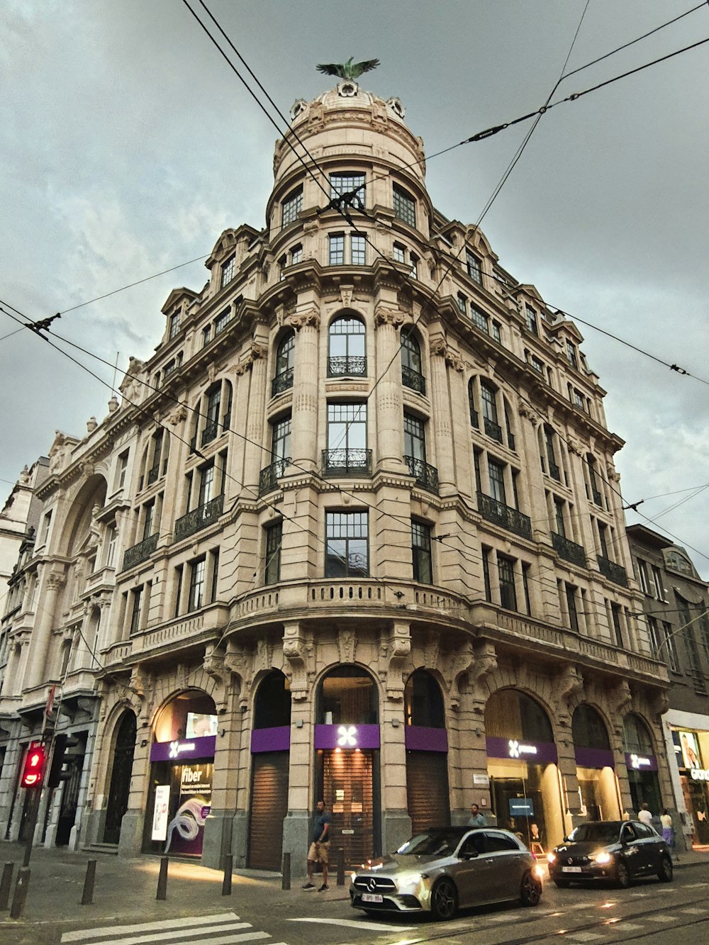 a very tall building sitting on the corner of a street