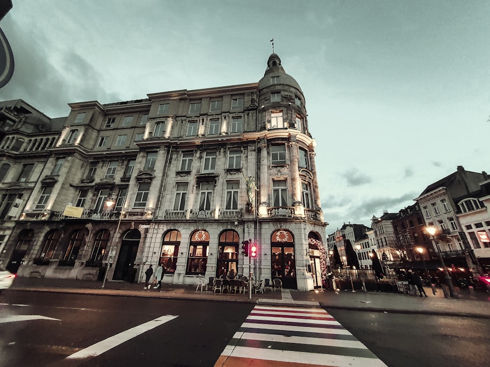 a very tall building sitting on the corner of a street