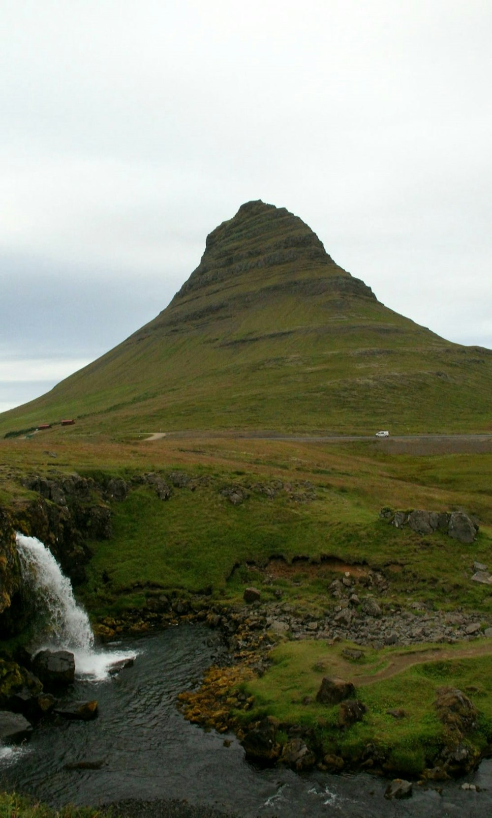 a mountain with a stream running through it