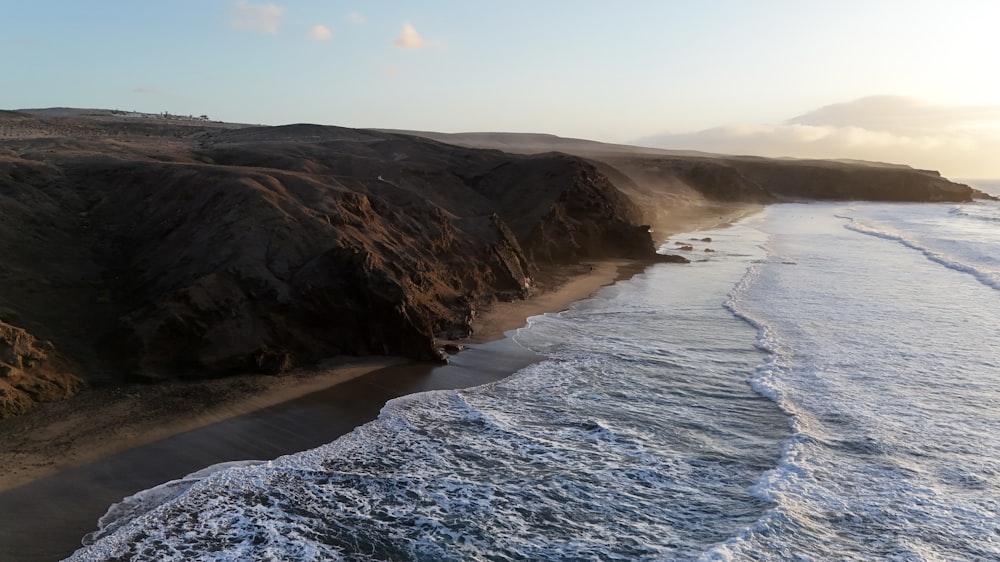 a view of a beach with waves coming in from the shore