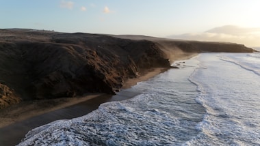 a view of a beach with waves coming in from the shore