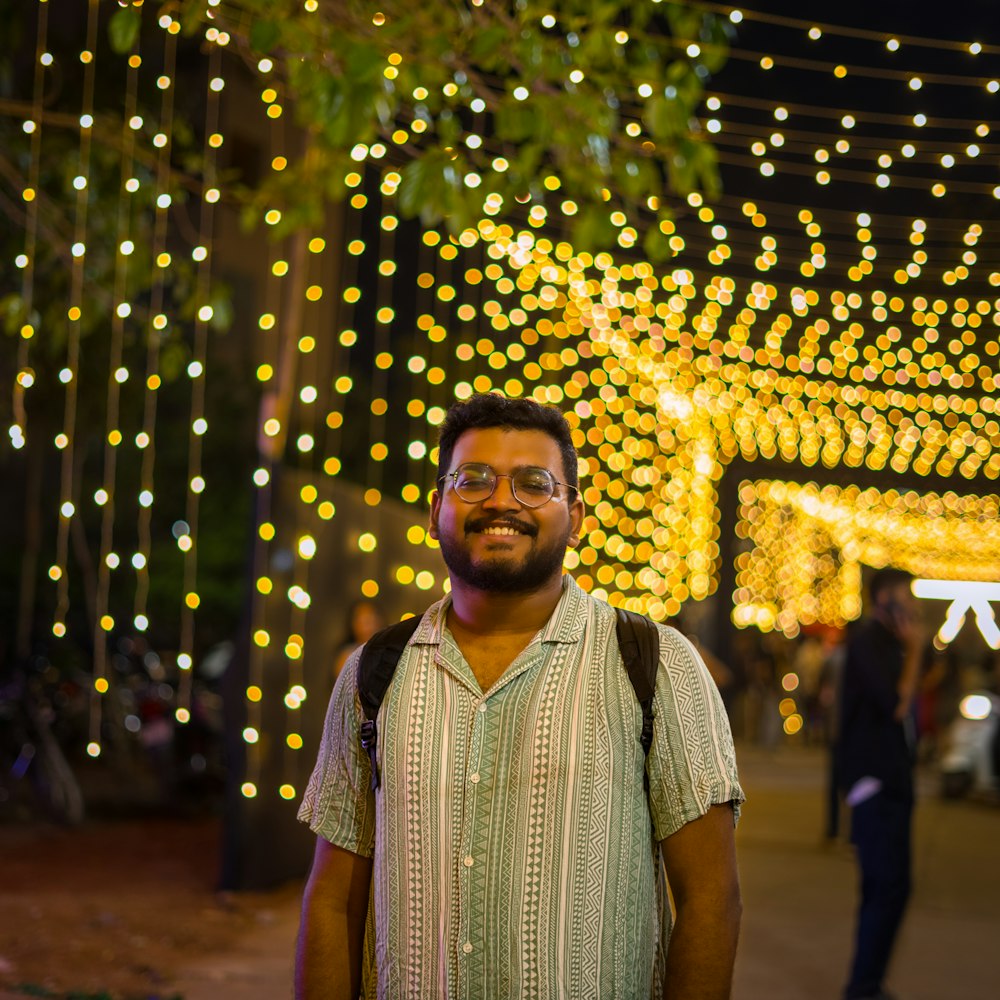 a man standing in front of a tunnel of lights
